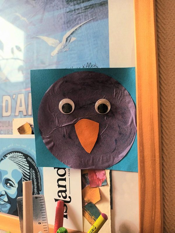 Collage of a bird with googly eyes