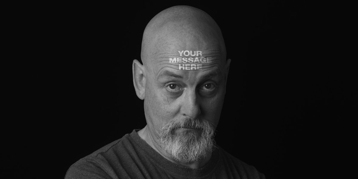 Jonathan Wilcock with the headline, 'YOUR MESSAGE HERE' on his forehead